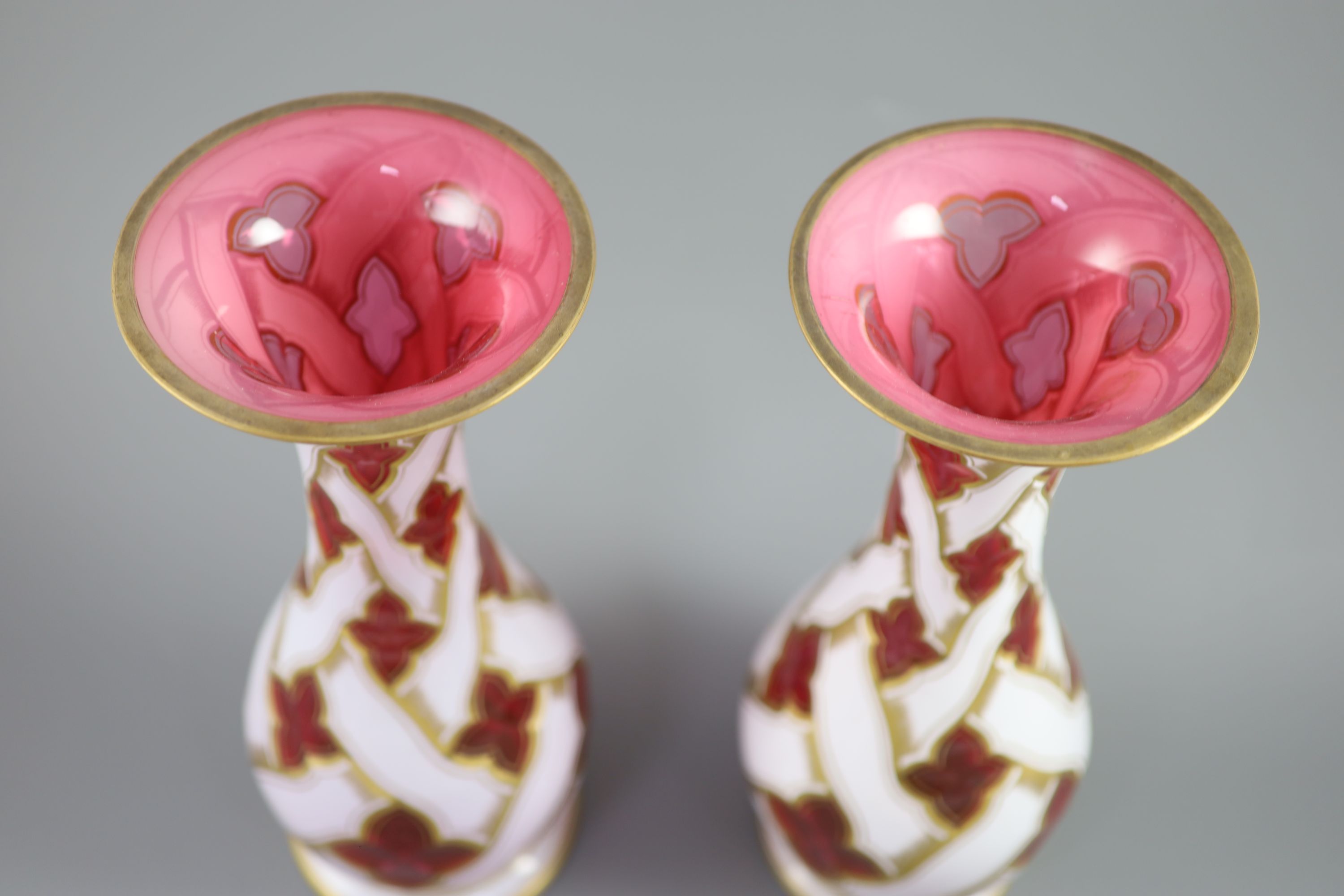A pair of Bohemian white and ruby overlaid glass baluster vases, late 19th century, 34cm high
